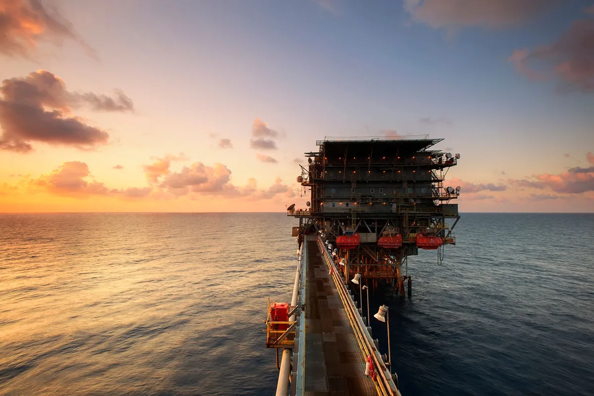 Industrial mining and oil extraction equipment in a landscape with investment infrastructure