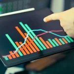 Marketer analyzing brand visibility and AI marketing metrics on computer dashboard