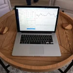 Professional reviewing SEO analytics and metrics on a computer screen in an office environment