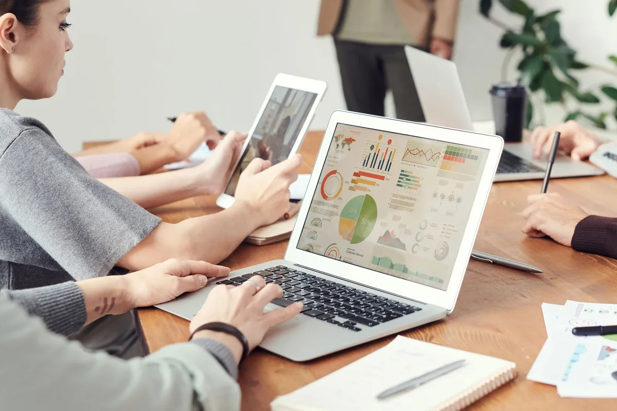 Team members reviewing analytics and software comparison data on a computer screen