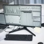 Person working on a laptop displaying AI analytics dashboards and data visualizations for marketing insights