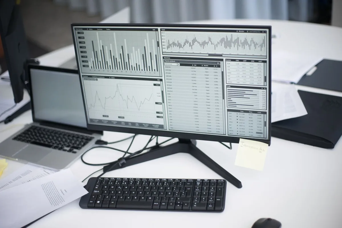 Person working on a laptop displaying AI analytics dashboards and data visualizations for marketing insights