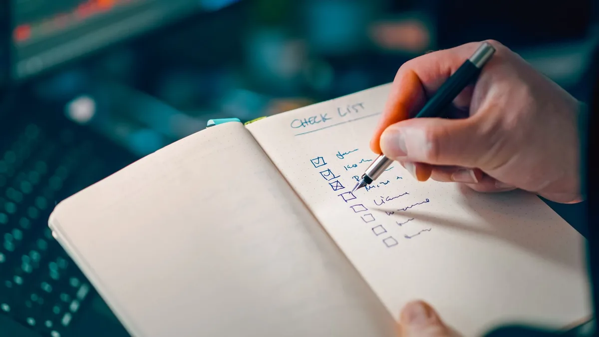 Marketing team planning strategy with checklist and workflow steps on whiteboard
