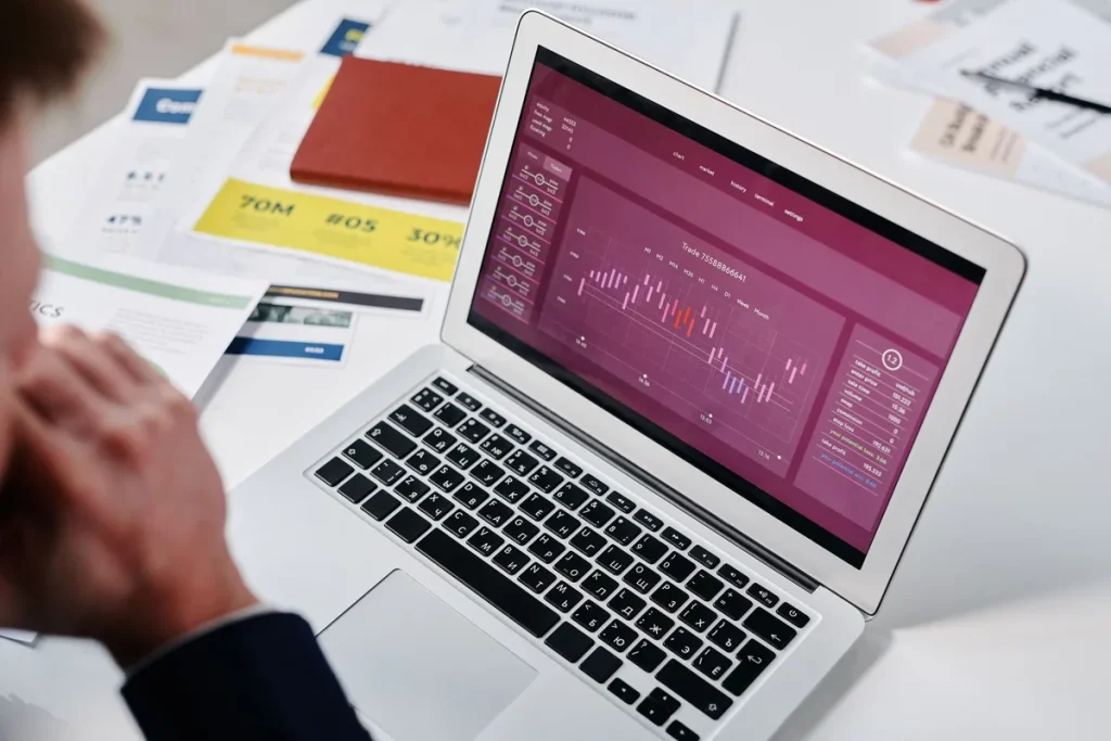 Laptop screen showing analytics charts and performance metrics on a workspace desk