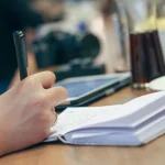 Marketing professional comparing software platforms on computer screens at desk