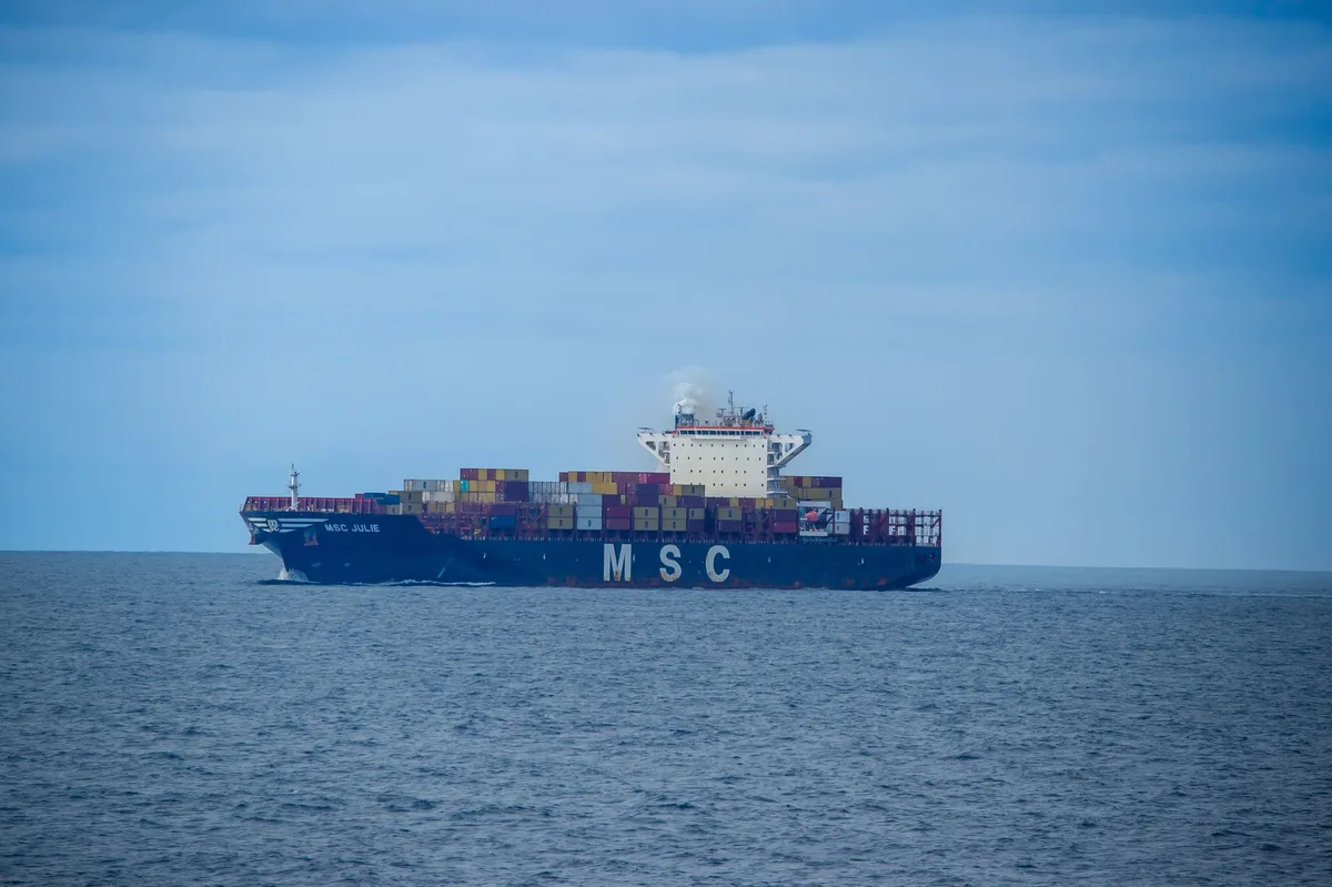 Damaged container ship with fire damage after missile strike in Gulf of Oman
