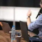 Silhouette of a conference table with microphone and economic report, evoking Fed decision-making