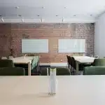 Anonymous marketing workspace with laptop charts and whiteboard diagrams