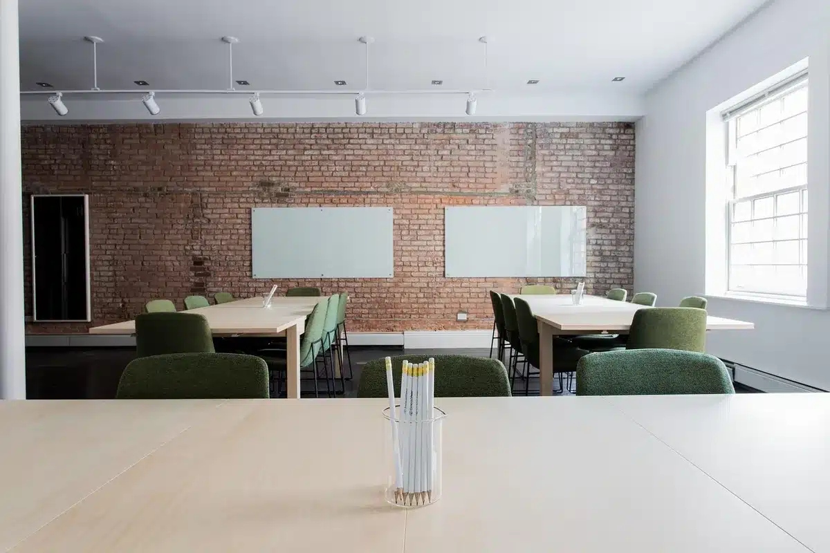 Anonymous marketing workspace with laptop charts and whiteboard diagrams