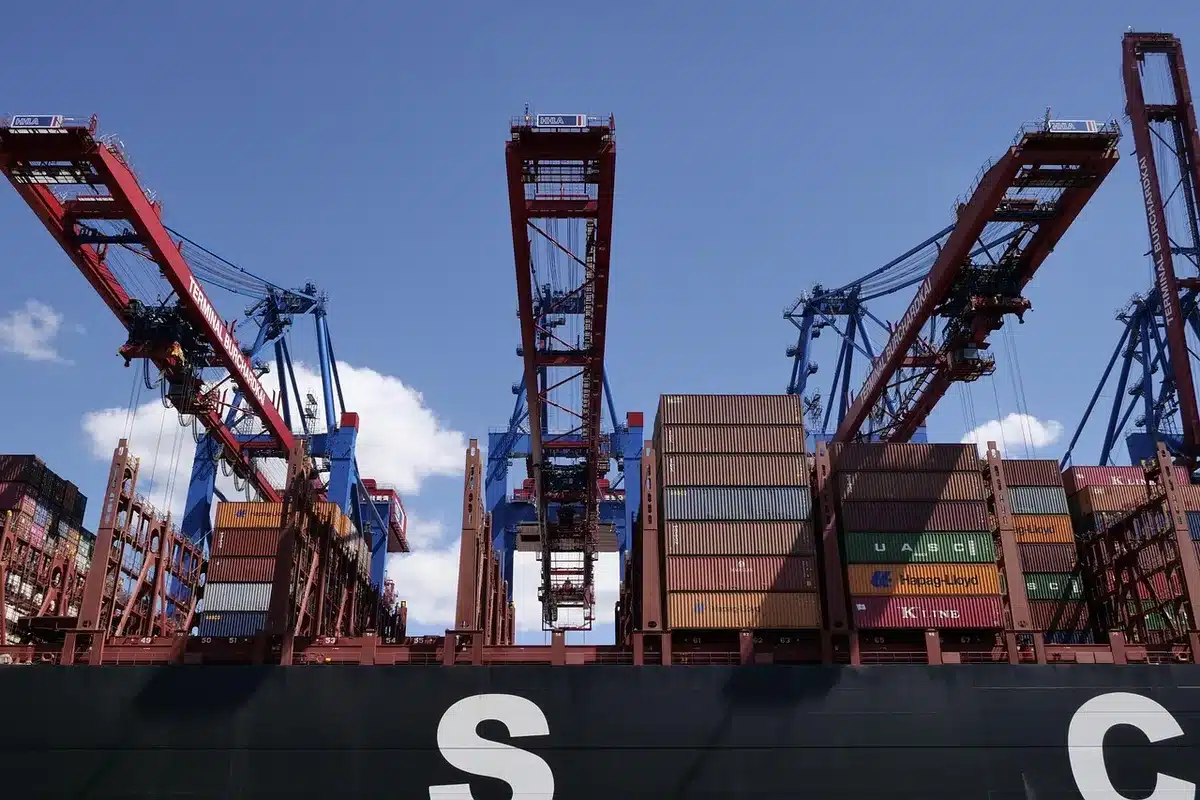 Containers stacked at an Argentine port with ships loading