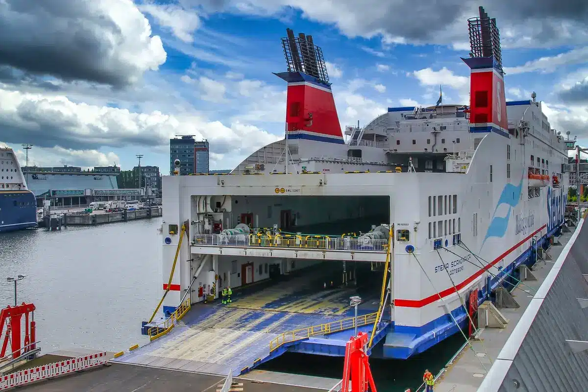A small cargo ferry being loaded at a southern port, ready for a short sea route
