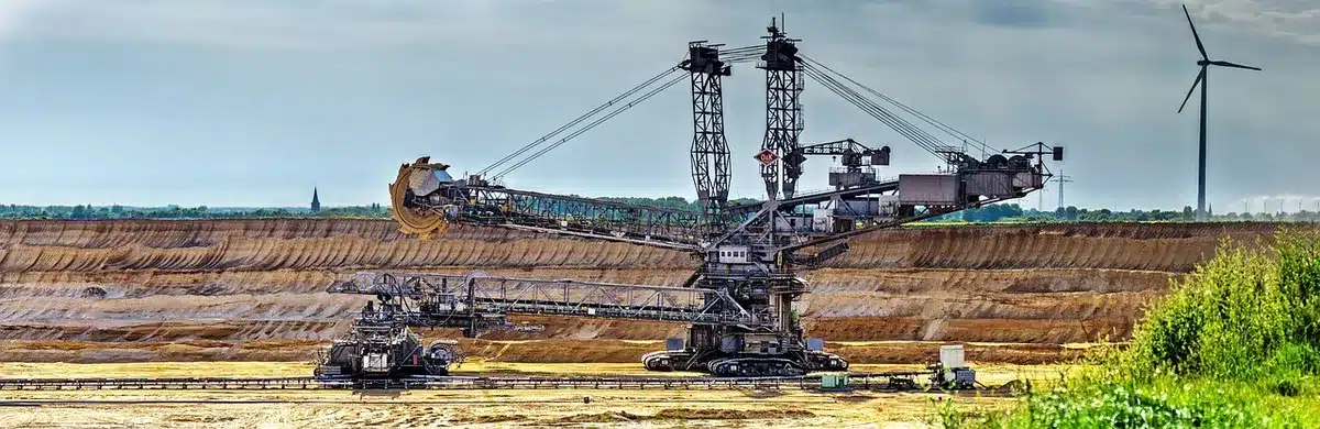 Open-pit lithium mining with heavy equipment under clear sky